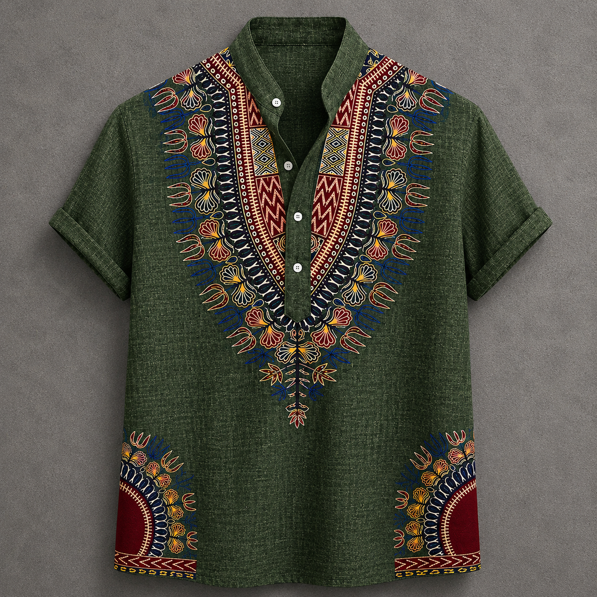 An olive green short-sleeve button-up shirt with vibrant multicolor African wax print embroidery on the V-neck collar and lower hem, displayed flat against a textured gray background.