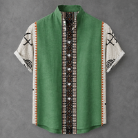 A short-sleeve button-up shirt with a green body, white patterned sleeves, and a central black, white, and orange geometric patterned placket, displayed flat against a gray background.
