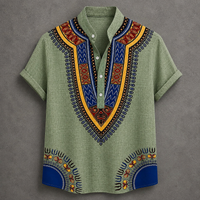 A men's short-sleeve button-up shirt in sage green with a vibrant African dashiki print. The shirt features a V-neck collar with geometric patterns in blue, yellow, orange, and black, and matching patterns are printed on the lower front hem.