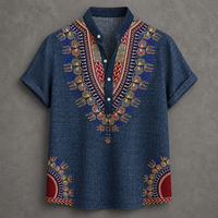 A short-sleeve button-up shirt in blue denim-like fabric with colorful African dashiki-style embroidery around the V-neck and lower hem, shown flat against a textured gray background.