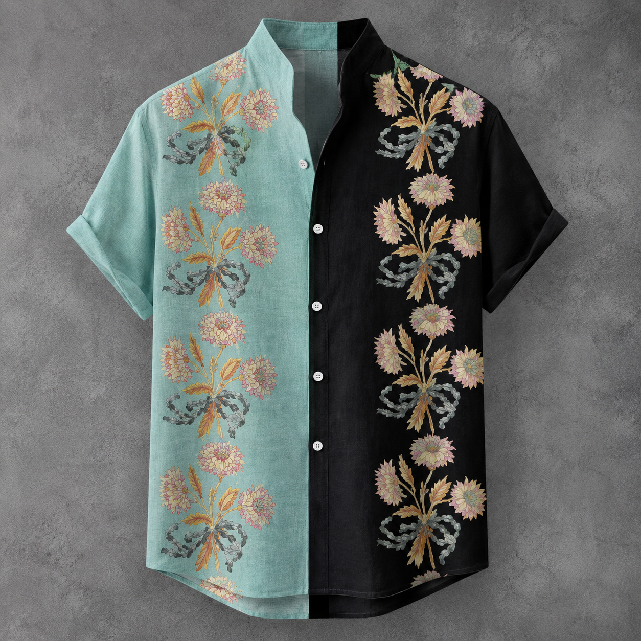 A short-sleeve button-front shirt with a split design: one half is light aqua with floral embroidery, and the other half is black with matching floral embroidery. The flowers are in muted pink, beige, and olive tones.