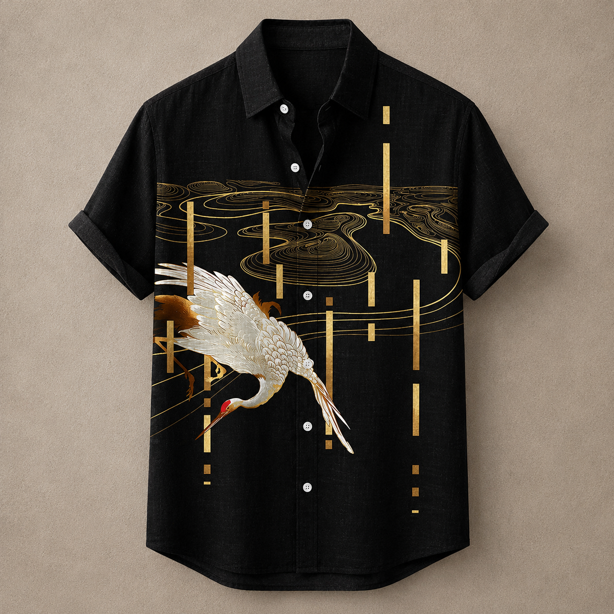 A black short-sleeve button-up shirt with a printed design featuring a white crane and gold abstract water and vertical line patterns, displayed against a neutral beige background.