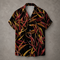 A short-sleeve button-up camp shirt with a black background and an all-over tropical leaf print in red, burgundy, and yellow, displayed flat against a textured gray background.