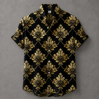A short-sleeve button-up camp shirt with a black background and an ornate gold damask pattern, laid flat on a textured gray background.