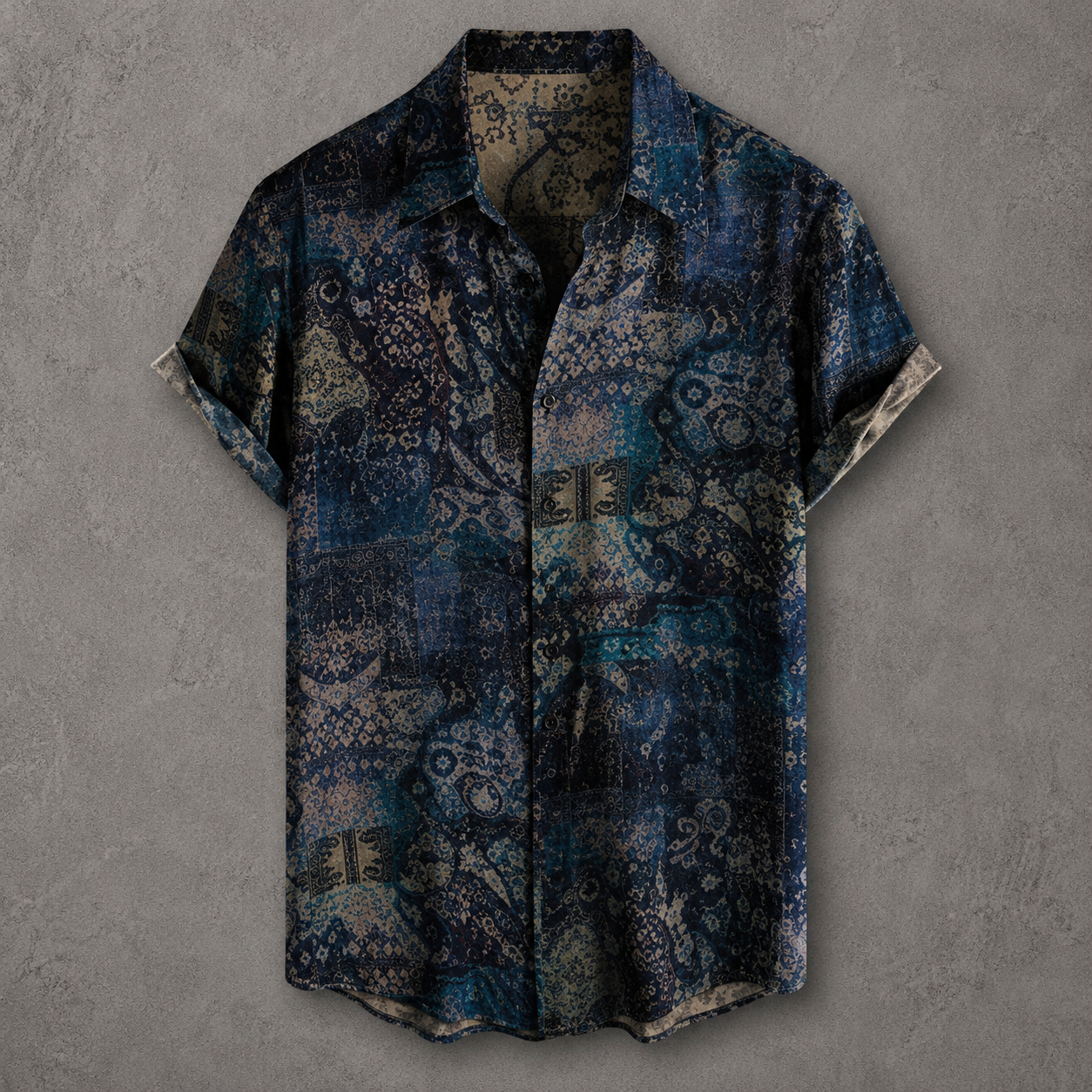 A short-sleeve button-up shirt with an intricate blue, navy, and beige paisley pattern, displayed against a textured gray background.