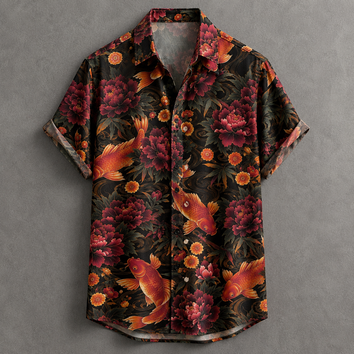 A short-sleeve button-up shirt with a black background and an all-over print of red and orange koi fish, peony flowers, and orange marigold flowers, displayed flat against a textured gray background.