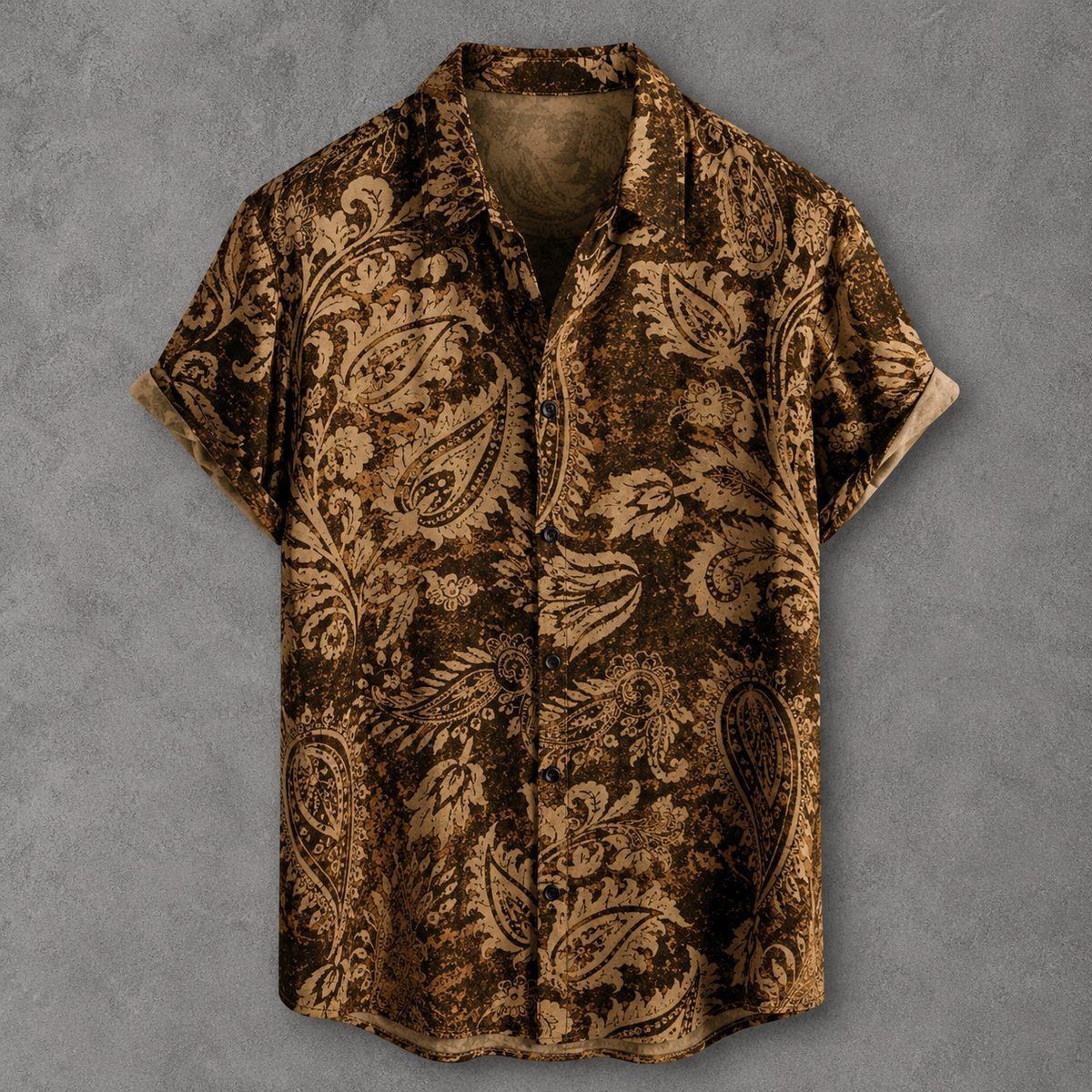 A short-sleeve button-up shirt with an intricate brown and beige paisley pattern, displayed flat against a textured gray background.