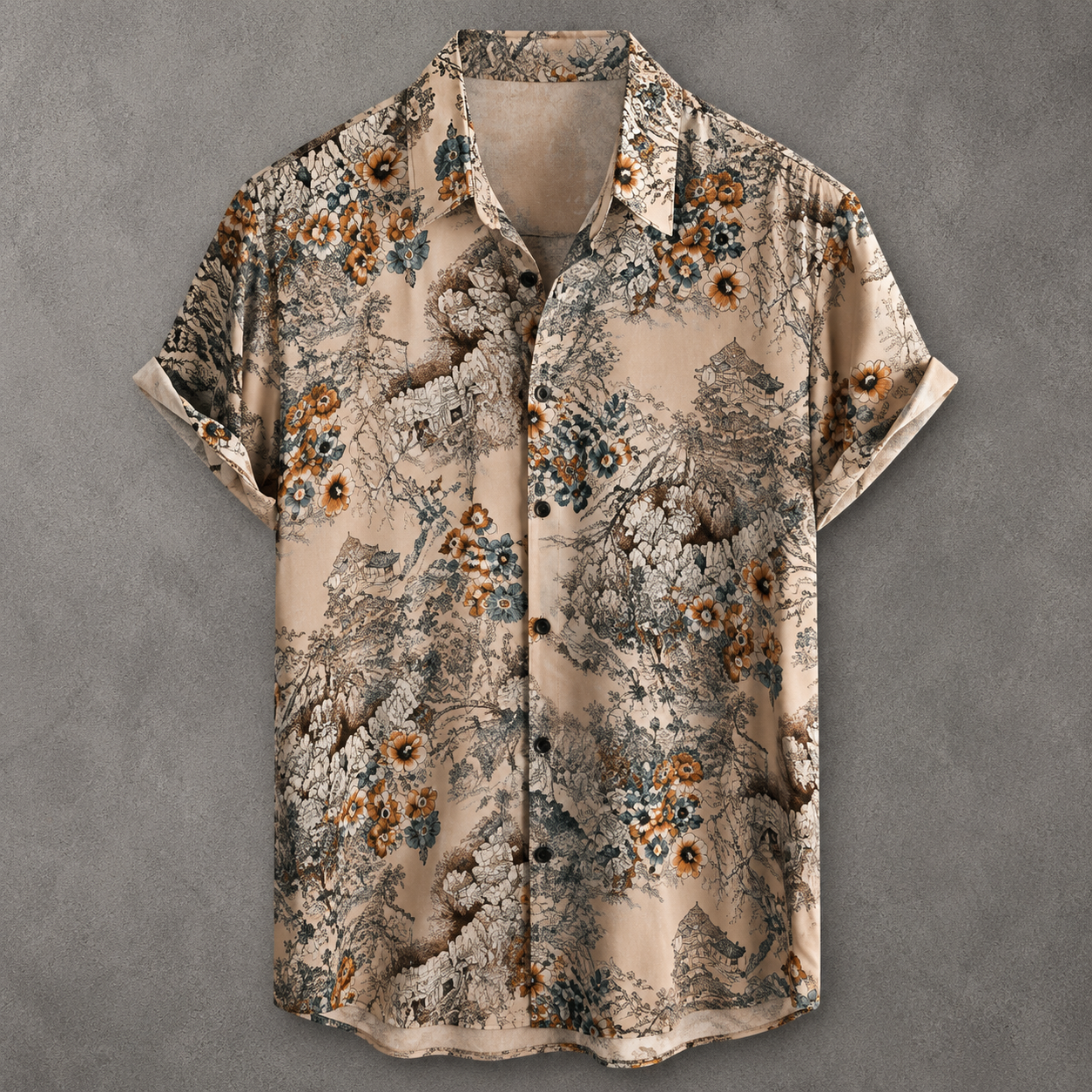 A short-sleeve button-up shirt with a beige base and an intricate, painterly floral and landscape pattern in brown, gray, and muted blue, laid flat against a textured gray background.