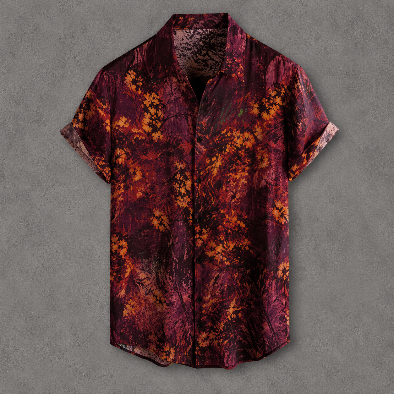 A short-sleeve button-up shirt with an abstract floral pattern in deep burgundy, maroon, and orange, displayed flat against a textured gray background.