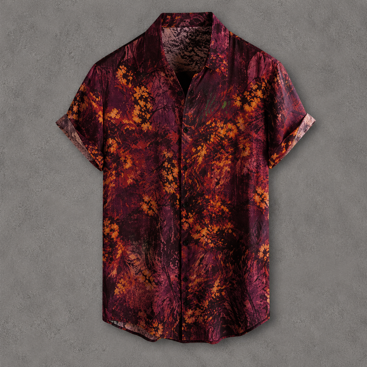 A short-sleeve button-up shirt with an abstract floral pattern in deep burgundy, maroon, and orange, displayed flat against a textured gray background.