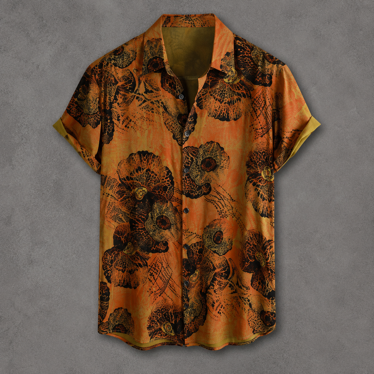 A short-sleeve button-up shirt with a vibrant orange and black abstract floral pattern, displayed flat against a textured gray background.