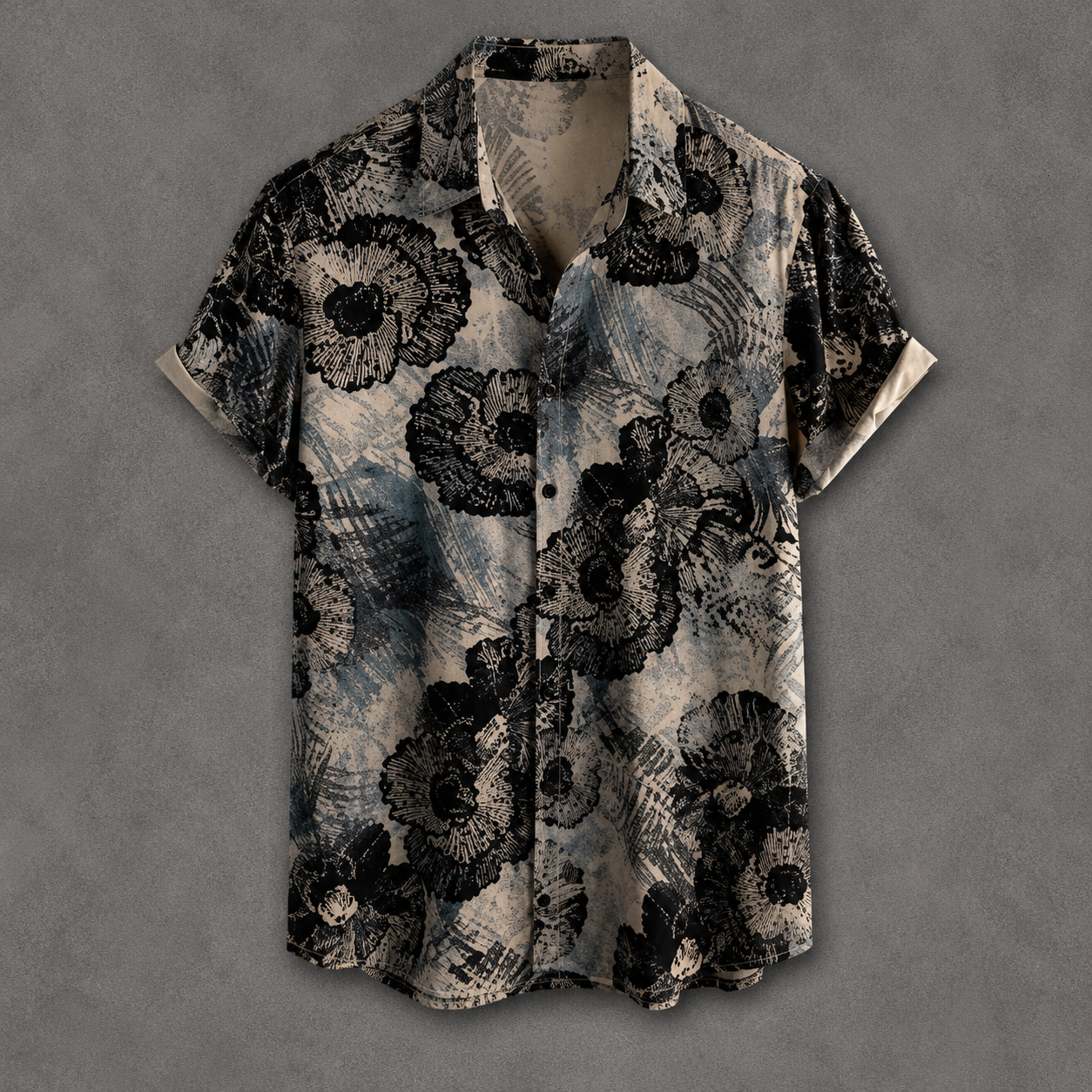 A short-sleeve button-up shirt with a black and gray abstract floral pattern on a textured beige background, displayed flat against a gray backdrop.