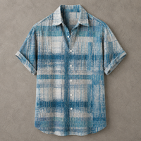 A short-sleeve button-up shirt with a blue and off-white textured plaid pattern, laid flat on a textured gray background.