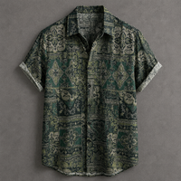 A short-sleeve button-up shirt with a dark green and beige bohemian-style geometric pattern, laid flat on a textured gray background.