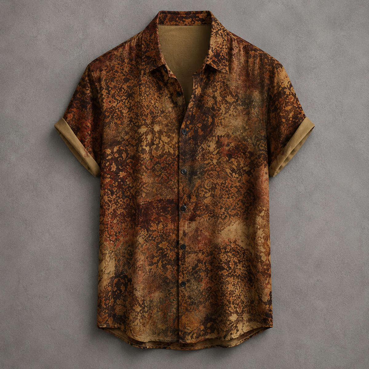 A short-sleeve button-up shirt with an abstract mottled pattern in earthy brown, rust, and tan tones, displayed flat against a textured gray background.
