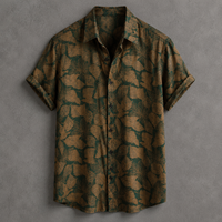 A short-sleeve button-up shirt with an abstract organic leaf-like pattern in dark green and brown, displayed flat against a textured gray background.