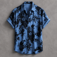 A short-sleeve button-up shirt in light blue with a black floral and botanical print, laid flat against a textured gray background.