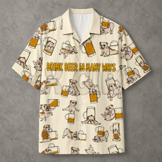 A short-sleeve button-up camp shirt with a cream background, featuring a repeating pattern of bulldog illustrations holding beer mugs and the text 'DRINK BEER IN MANY WAYS' across the chest. The shirt is displayed flat against a textured gray background.