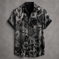 A short-sleeve button-up shirt with a black and gray floral and paisley pattern, laid flat against a textured gray background.