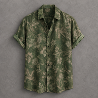 A short-sleeve button-up shirt in olive green with a beige floral pattern, laid flat against a textured gray background.