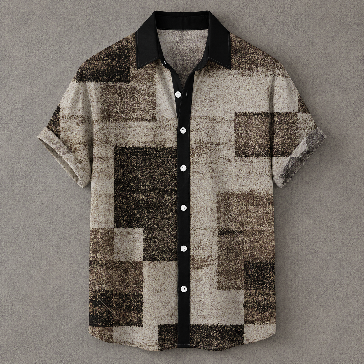 A short-sleeve button-up shirt with a textured geometric pixelated pattern in shades of brown, beige, and black, featuring a solid black collar and button placket with white buttons, displayed flat against a gray background.