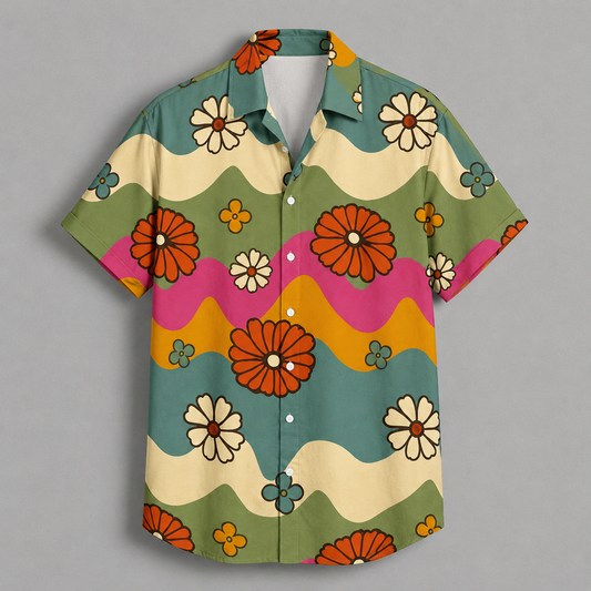 A short-sleeve button-up shirt with a retro 70s floral pattern, featuring wavy stripes of olive green, cream, pink, and mustard yellow, decorated with orange, white, and blue flowers, shown flat on a gray background.