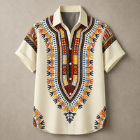 A short-sleeve button-up shirt with a cream base and a vibrant African dashiki-style print in orange, red, yellow, and black, displayed flat against a neutral gray background.