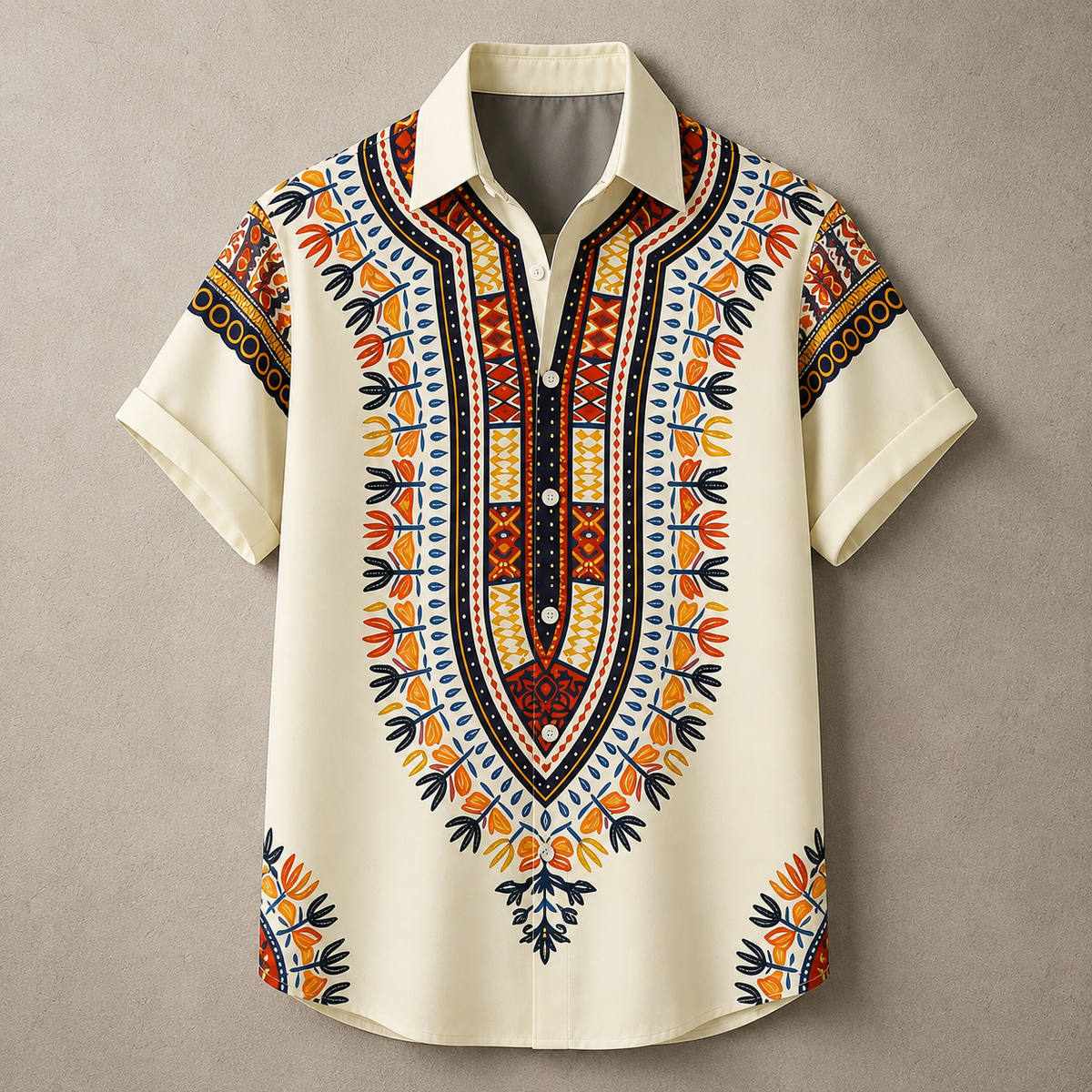 A short-sleeve button-up shirt with a cream base and a vibrant African dashiki-style print in orange, red, yellow, and black, displayed flat against a neutral gray background.