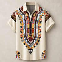 A short-sleeve button-up shirt with a cream base and a vibrant, detailed African dashiki-style print in orange, yellow, blue, and red, displayed on a neutral textured beige background.