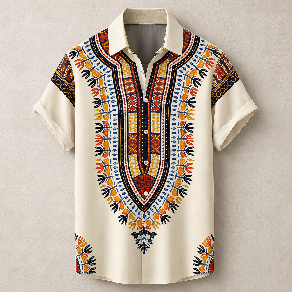 A short-sleeve button-up shirt with a cream base and a vibrant, detailed African dashiki-style print in orange, yellow, blue, and red, displayed on a neutral textured beige background.