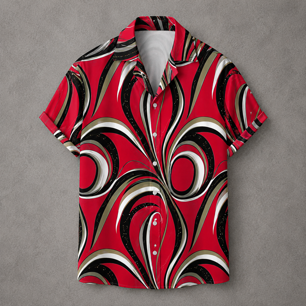 A short-sleeve button-up camp shirt with a bold retro swirl pattern in red, black, white, and beige, laid flat on a textured gray background.