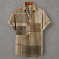 A short-sleeve button-up shirt with a distressed patchwork pattern in shades of beige, brown, and tan, hanging on a wooden hanger against a textured gray background.