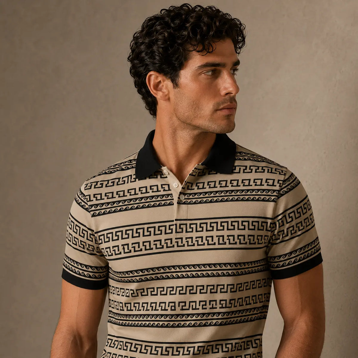 Man wearing a patterned polo shirt against a neutral background