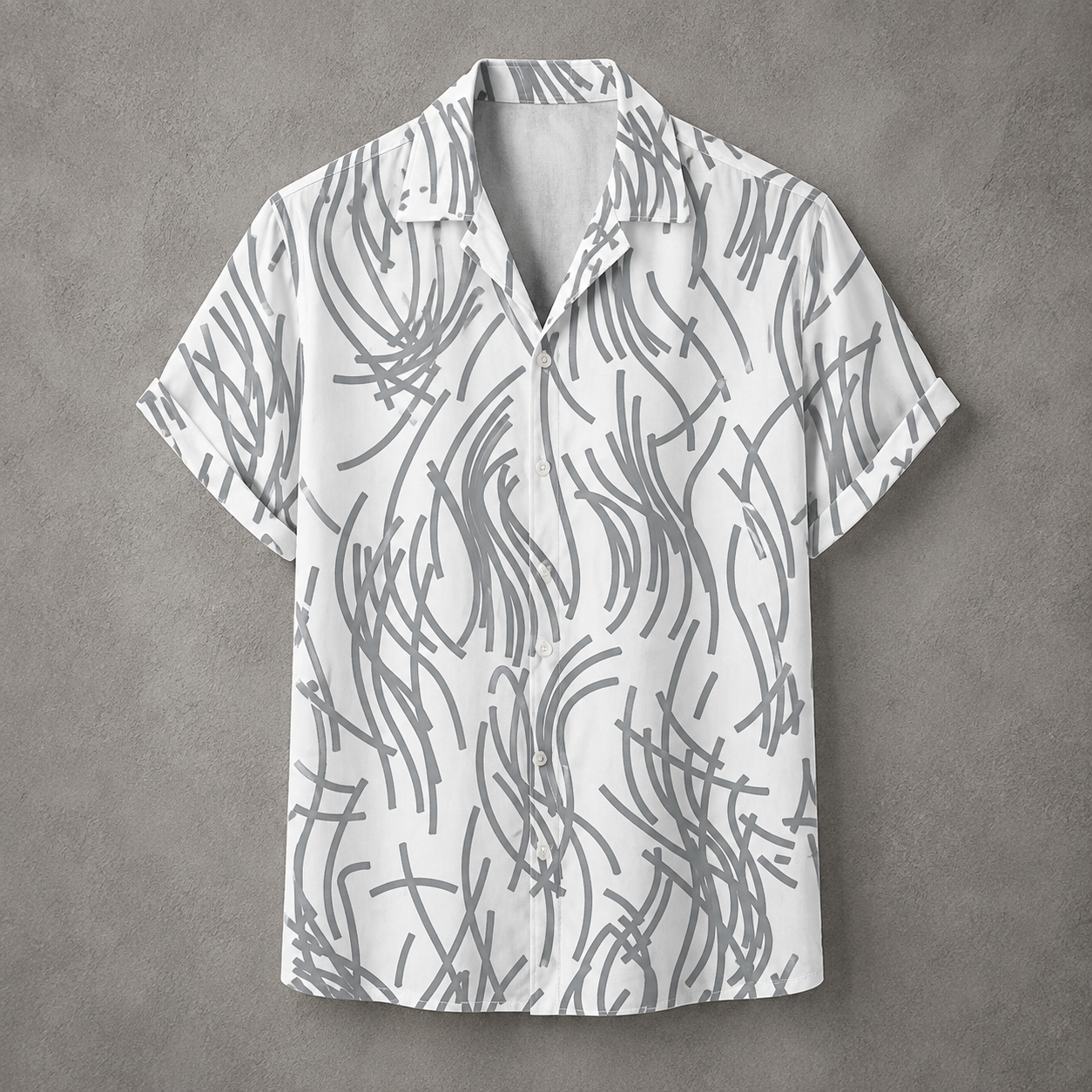 A short-sleeve button-up camp shirt with a white base and a gray abstract scribble pattern, displayed flat against a textured gray background.