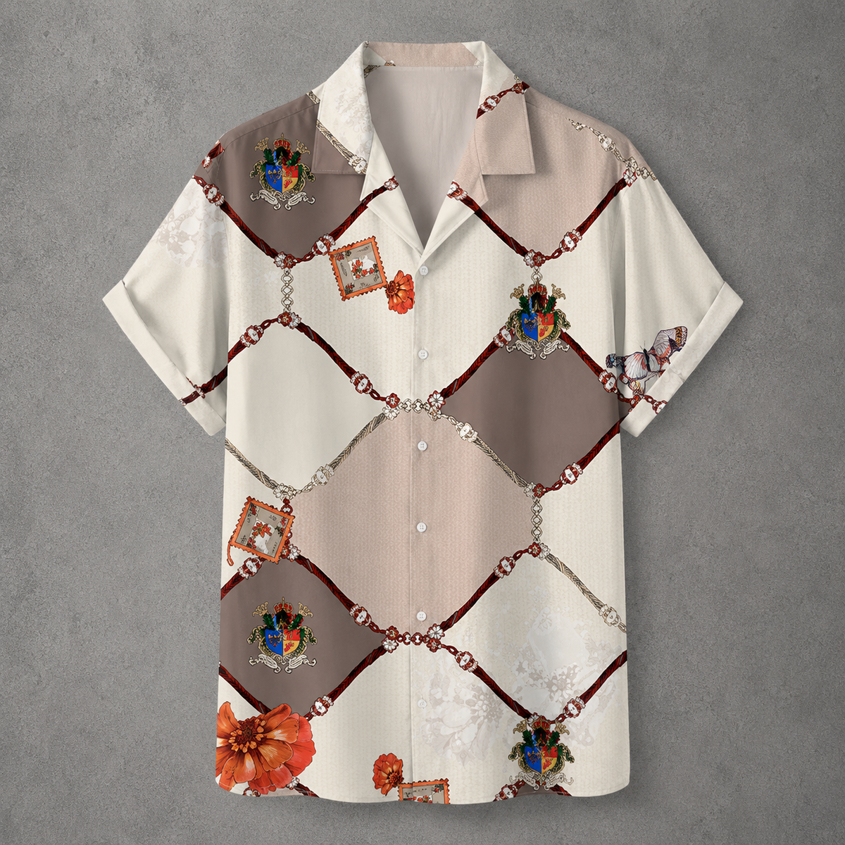 A short-sleeve button-up camp shirt with a beige and brown diamond pattern, featuring decorative chain and gem motifs, floral accents, and small crest details, displayed against a textured gray background.