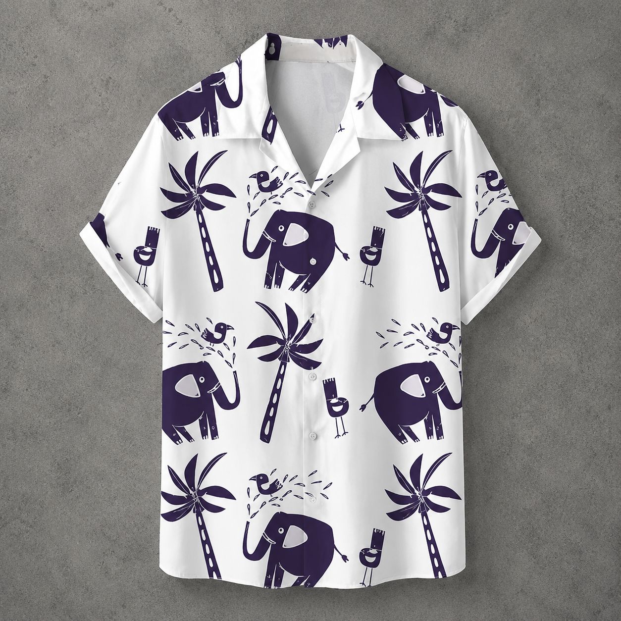 A white short-sleeve camp collar button-up shirt with a dark purple tropical print featuring elephants, palm trees, and cocktail glasses, displayed flat against a textured gray background.