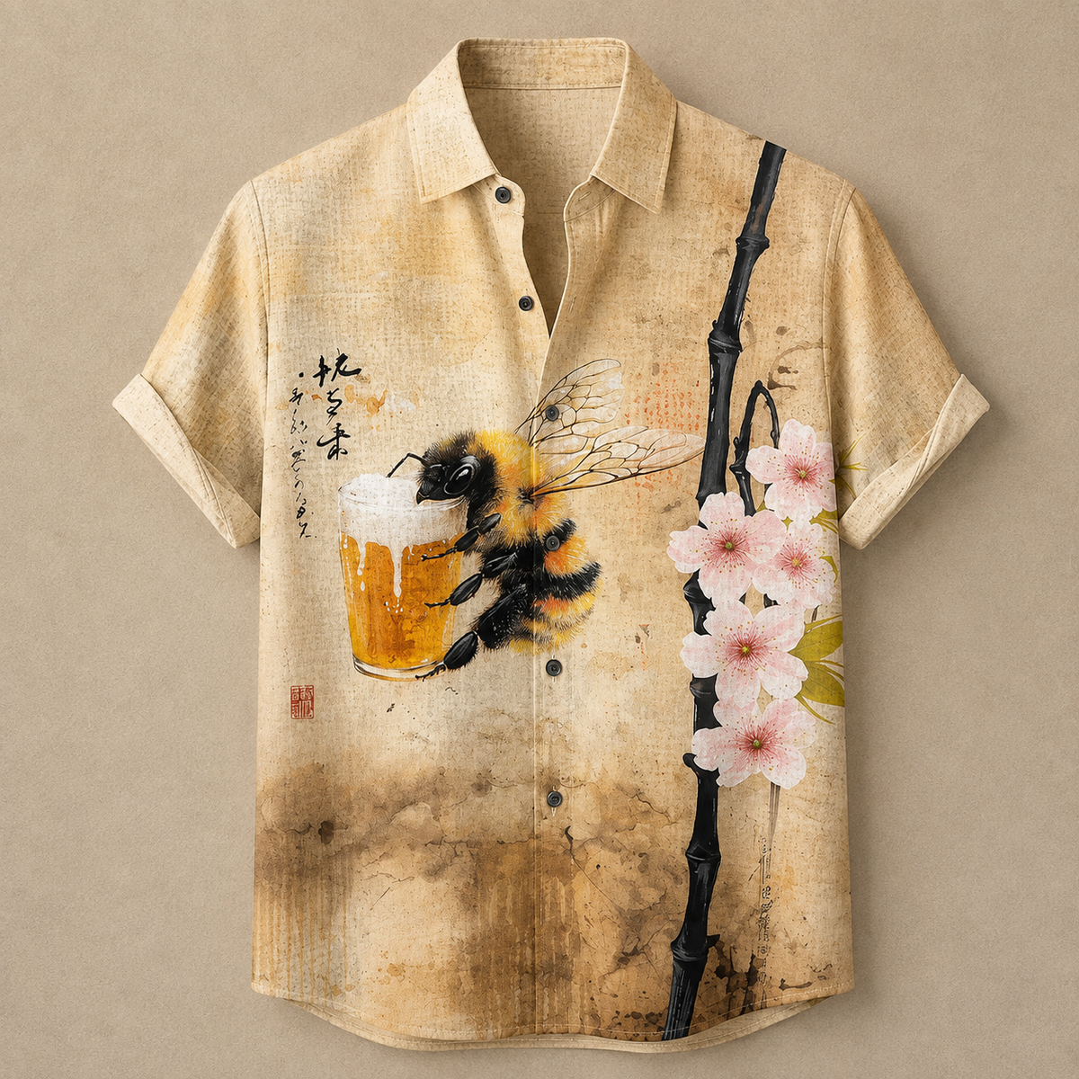 A beige short-sleeve button-up shirt with a vintage-style print featuring a bumblebee holding a glass of beer, pink blossoms, and black brushstroke details on a textured tan background.
