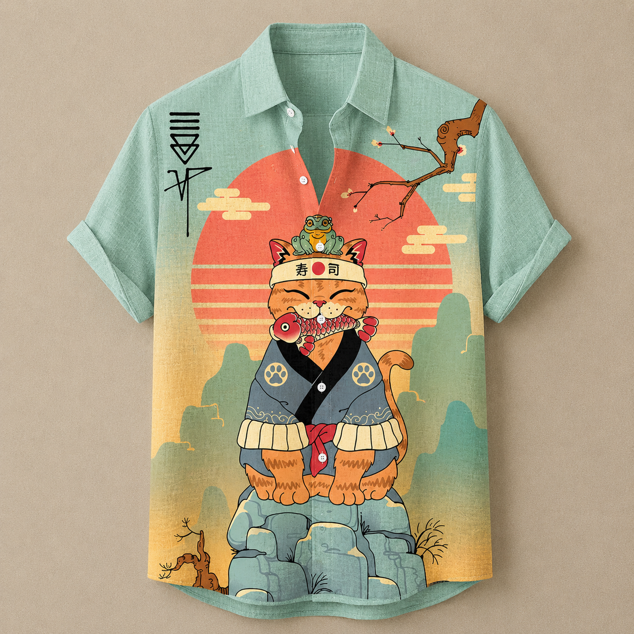 A short-sleeve button-up camp shirt with a light mint green base and a large, colorful graphic of an orange tabby cat dressed in traditional Japanese attire, set against a sunset and mountain background.