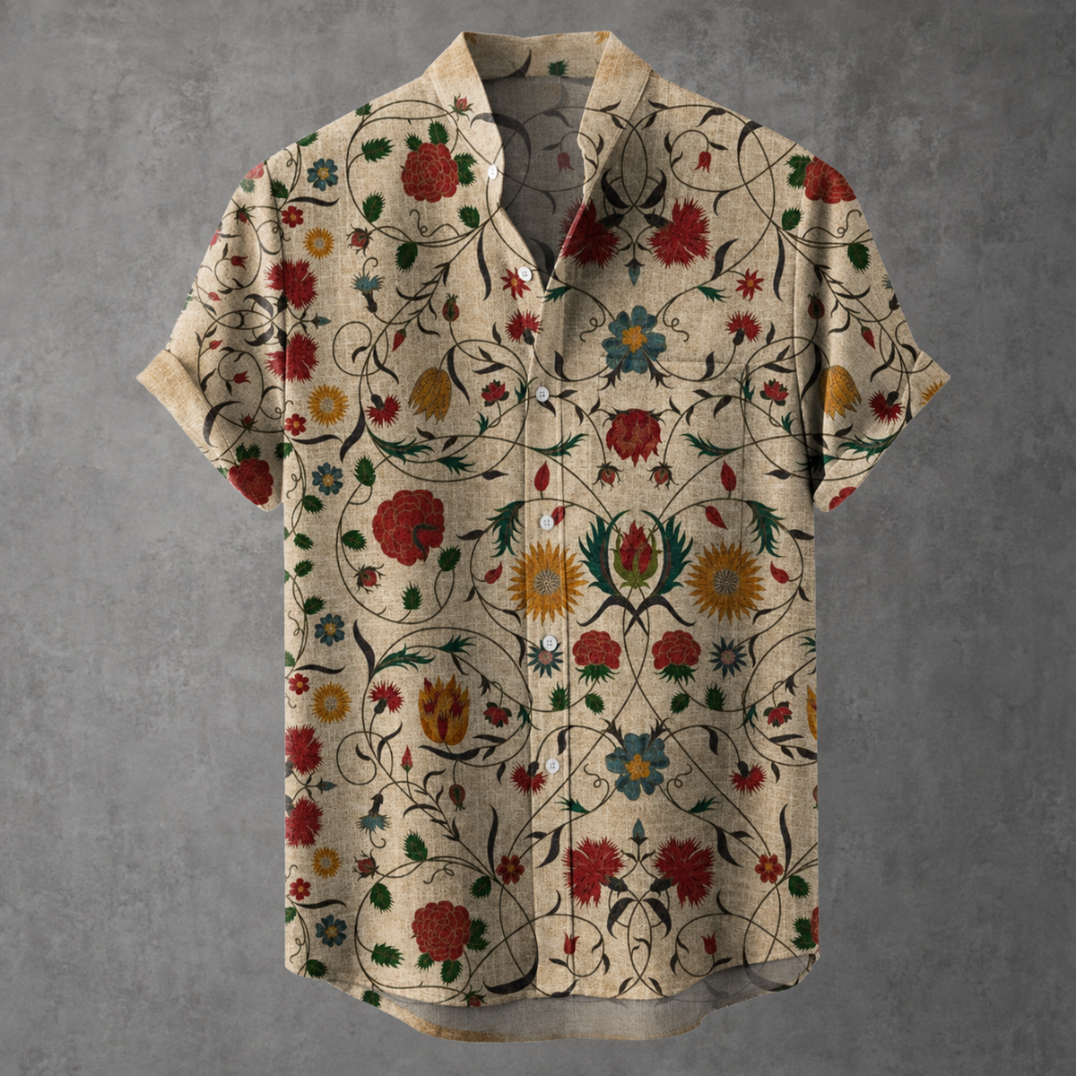 A short-sleeve button-up shirt with a beige base and an intricate, colorful floral and vine pattern, displayed against a textured gray background.