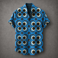 A short-sleeve button-up shirt with a bold blue, black, and beige geometric eye pattern, laid flat against a textured gray background.
