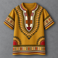 A mustard yellow short-sleeve t-shirt with a detailed African dashiki print in red, black, white, and orange, displayed flat against a textured gray background.