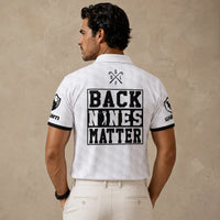 Man wearing a white polo shirt with 'Back Nines Matter' text and logos on a beige background