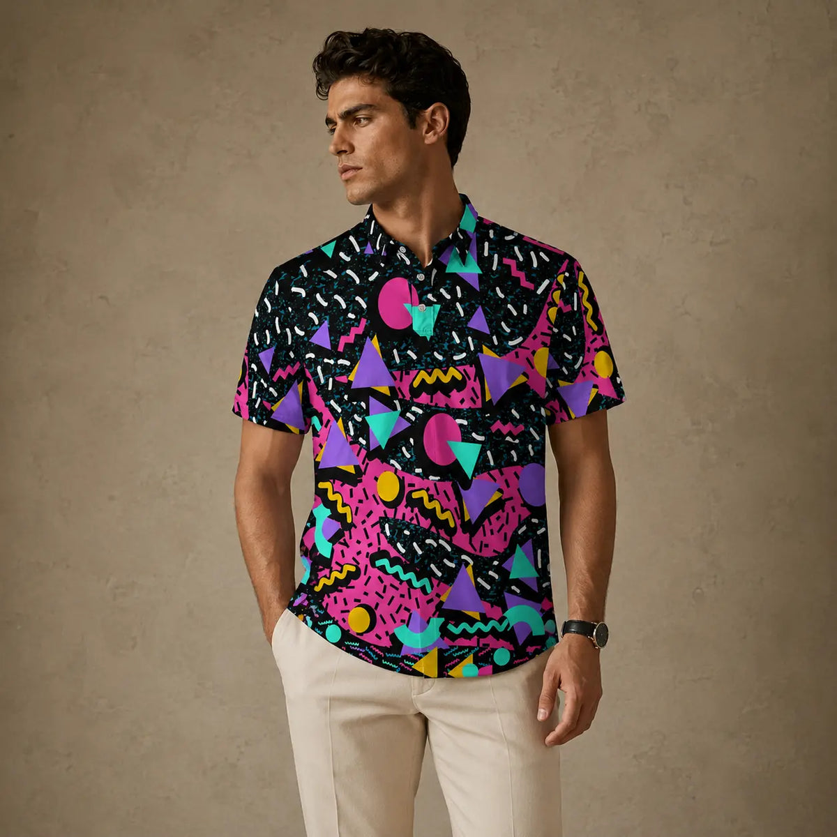 Man wearing a colorful geometric patterned shirt against a beige background