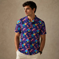 Man wearing a colorful patterned shirt against a beige wall