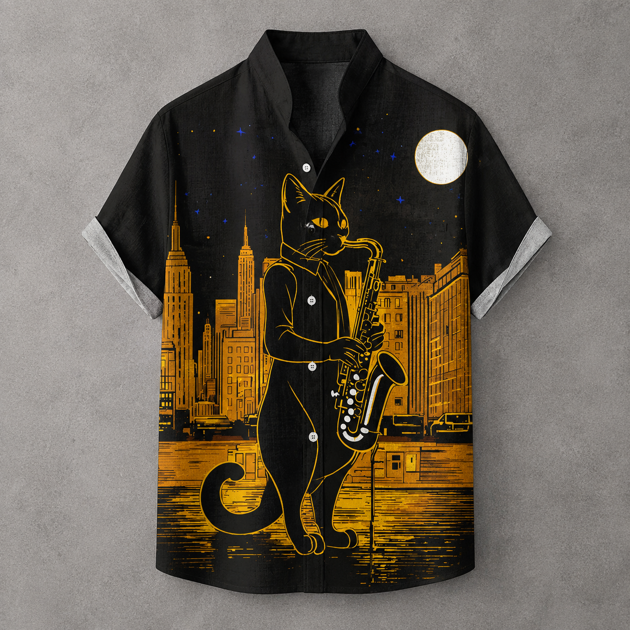 A short-sleeve button-up shirt with a black base and a detailed graphic print of a black cat in a suit playing a saxophone against a city skyline at night under a full moon.