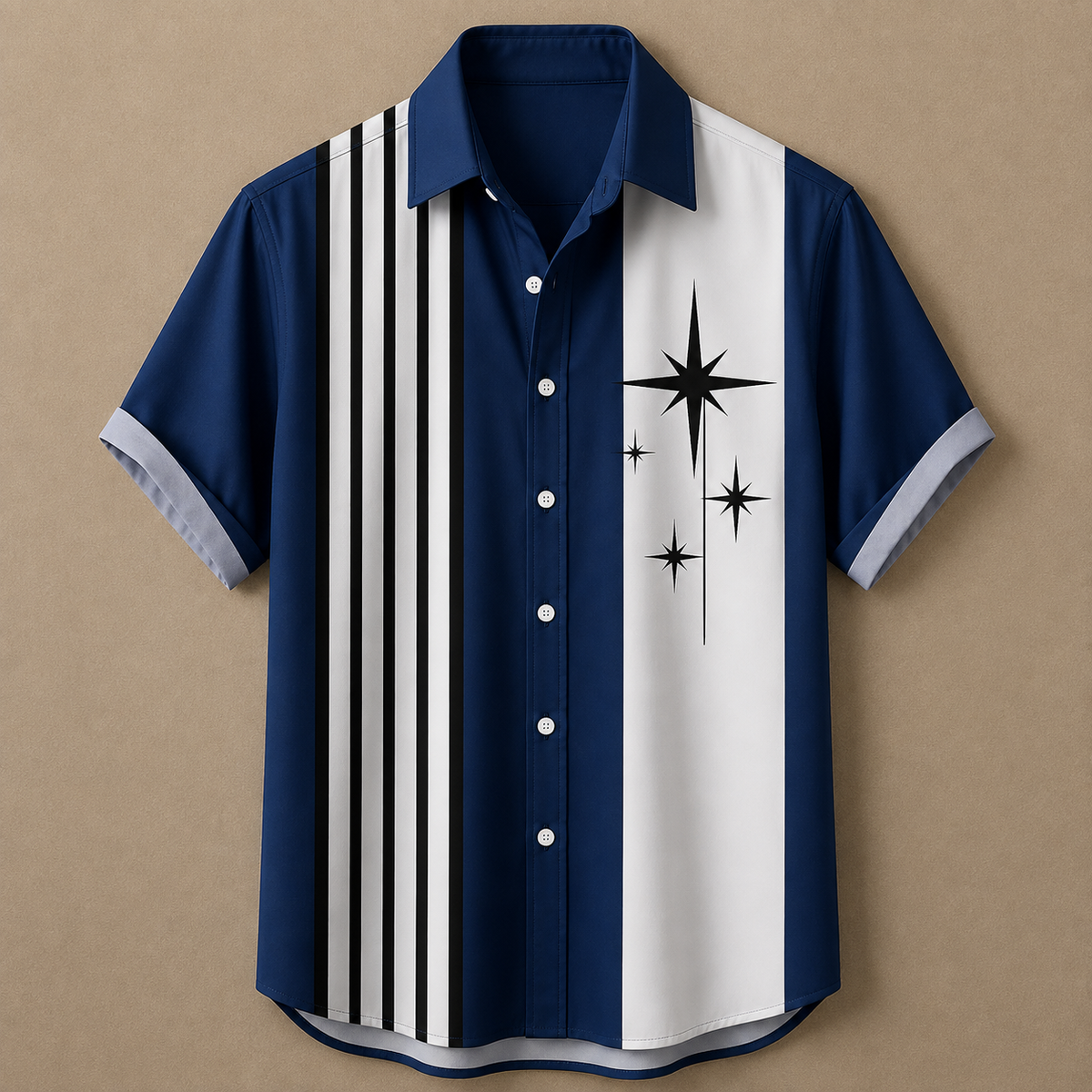 A short-sleeve button-up shirt laid flat on a tan background. The shirt is navy blue with a vertical white stripe on the right side, black vertical stripes on the left side, and black starburst graphics on the white stripe.