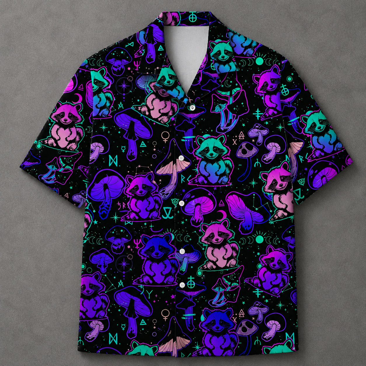A short-sleeve button-up camp shirt with a black background and a vibrant neon pattern of purple, pink, and teal raccoons, mushrooms, and occult symbols, displayed on a textured gray background.