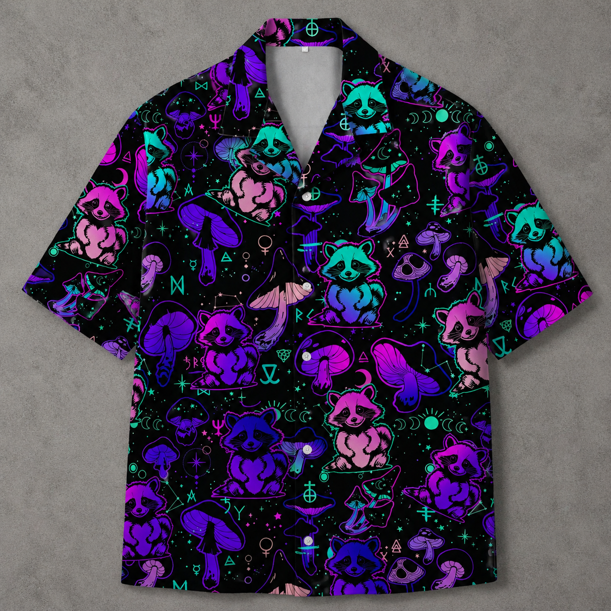 A short-sleeve button-up camp shirt with a black background and a vibrant neon pattern of raccoons, mushrooms, and occult symbols in purple, pink, and blue.