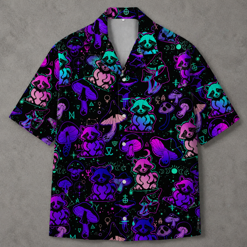 A short-sleeve button-up camp shirt with a black background and a vibrant neon pattern of raccoons, mushrooms, and occult symbols in purple, pink, and blue.