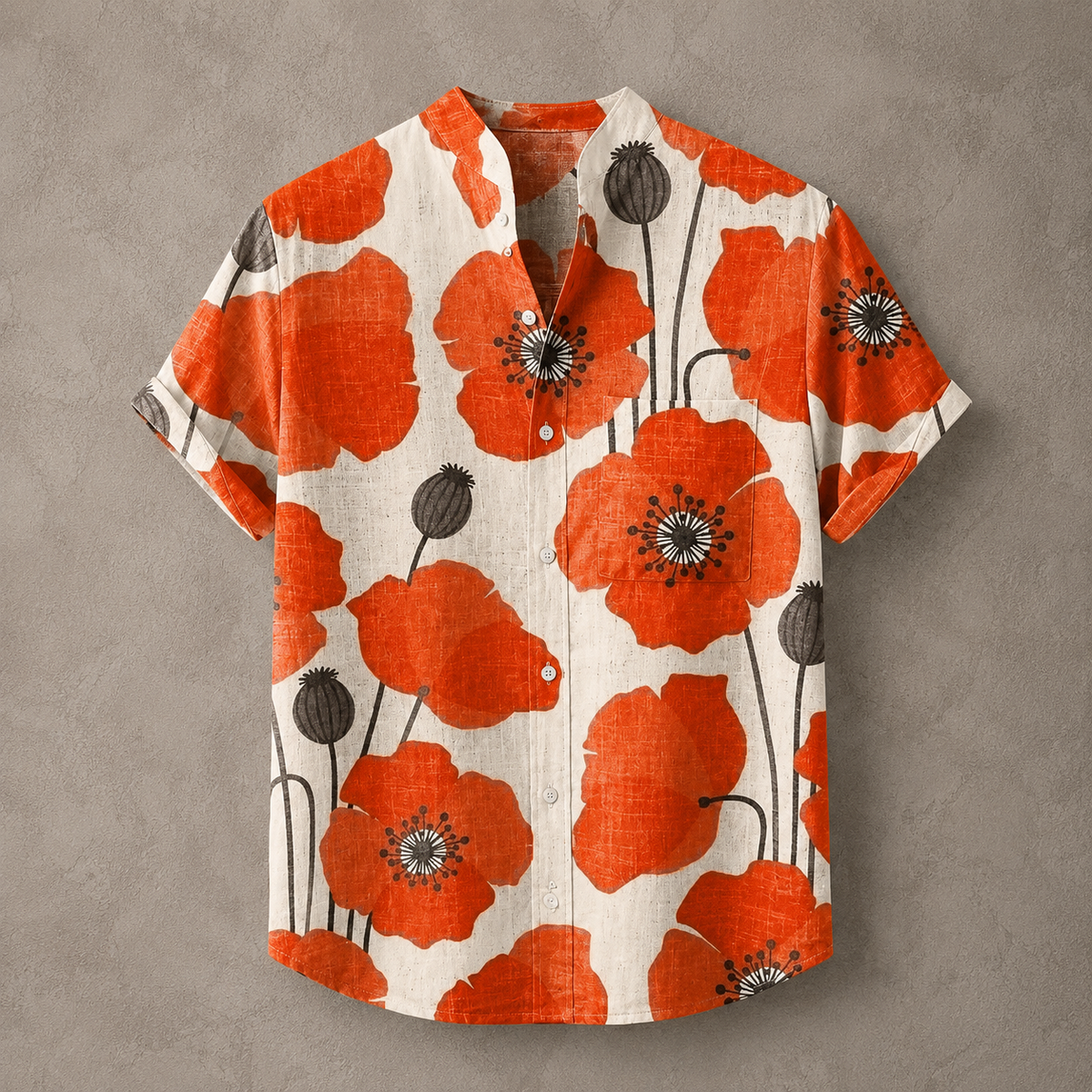 A short-sleeve button-up shirt with a vibrant orange poppy floral print on a textured cream linen background, displayed flat against a neutral gray wall.